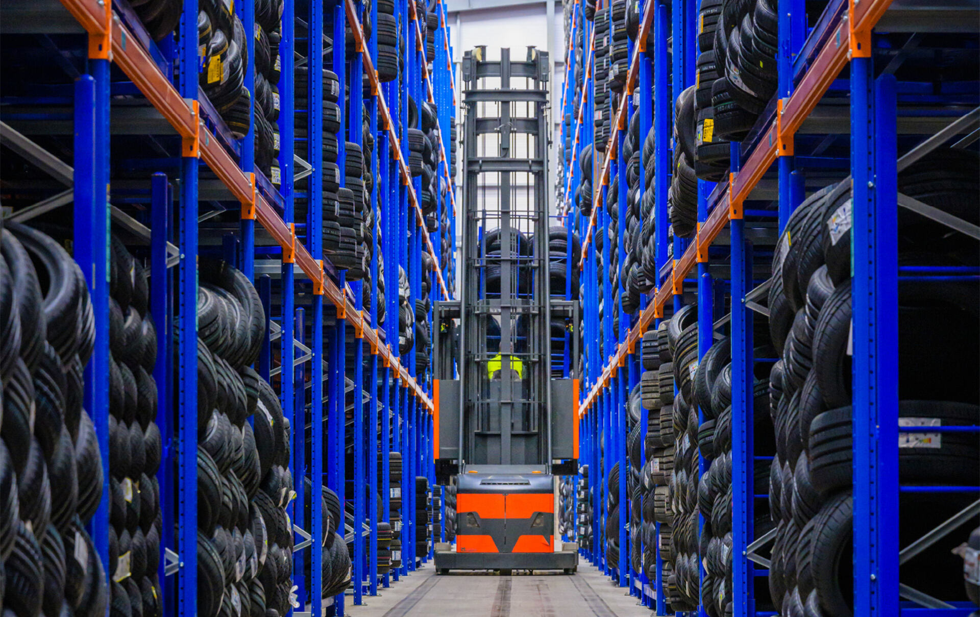 Reach truck in an aisle of the Modern Tyres tyre warehouse